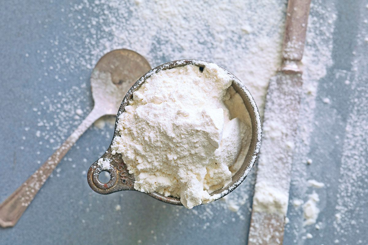 Vintage Flour Measuring cup with Flour, Spoon and knife for leveling.