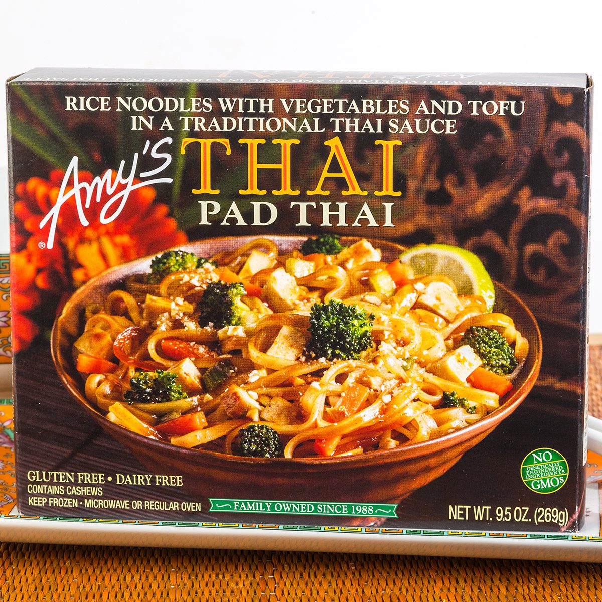 "Amy's THAI Pad Thai" frozen dinner in Oriental Setting with colorful dishes and chopsticks on bamboo place mat.