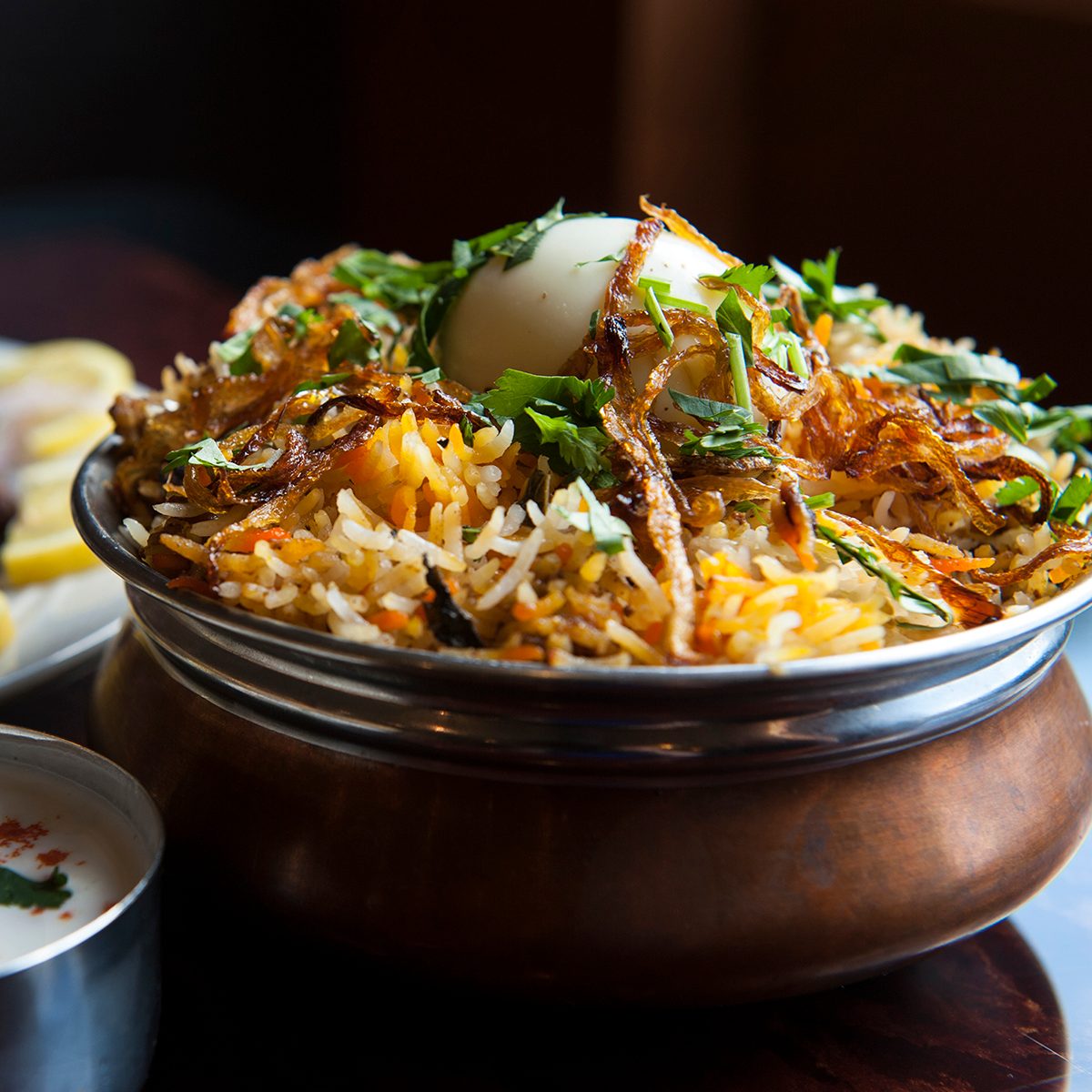 The hyderabadi chicken biryani is photographed at Akshaya Thursday May 9, 2013 in Sterling, VA. The restaurant features the Indo-Chinese cuisine. In the background at left is the lamb pepper fry.