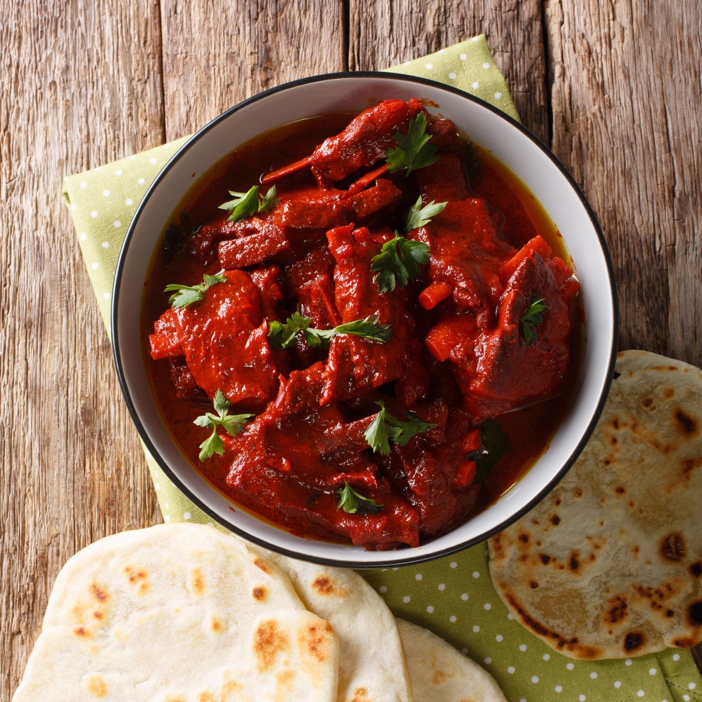 Junglee Maas is a traditional Rajasthani recipe, slowly stewed meat in a spicy sauce close-up. Vertical top view