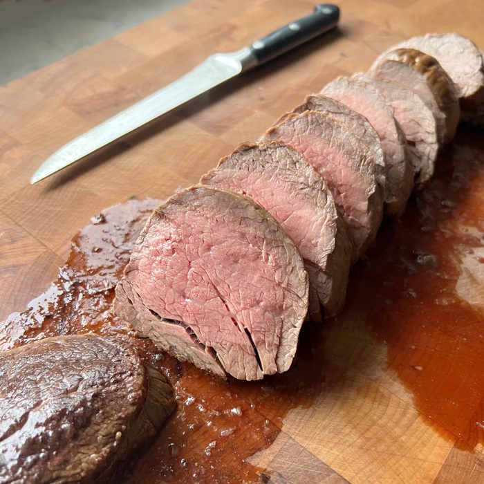 Ina Garten's Beef Tenderloin cut up on a cutting board