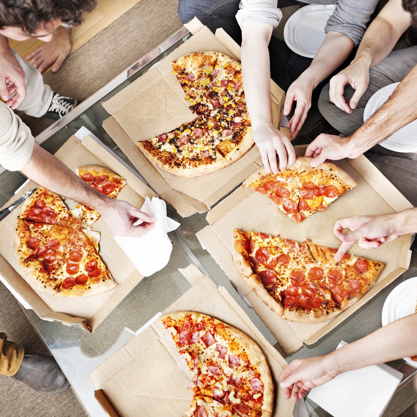 People taking pizza slices