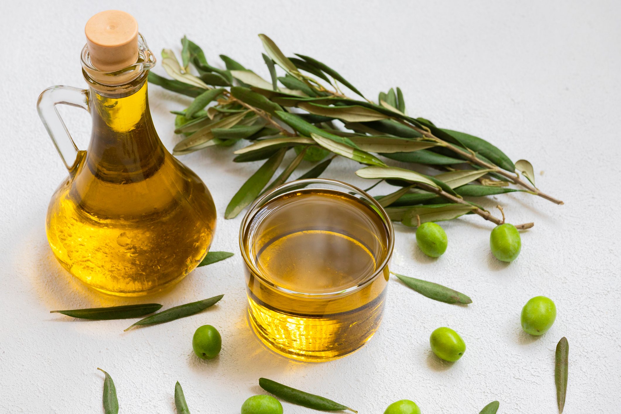 Image of raw olives and olive oil