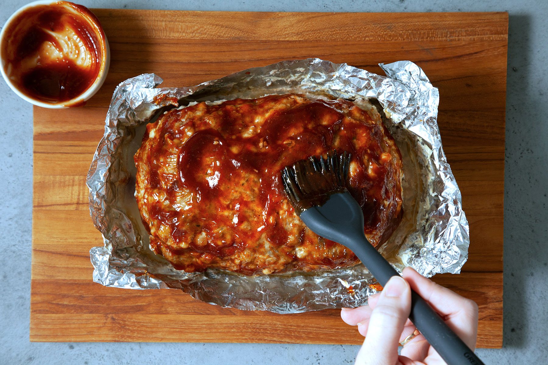 Applying Sauce to Instant Pot Meat Loaf with brush