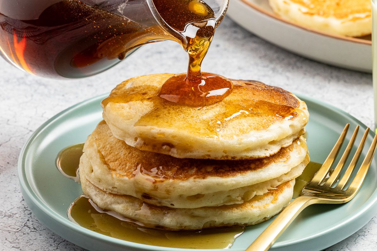 Taste of Home Homemade Pancake Syrup recipe photo of the finished recipe with pancakes.