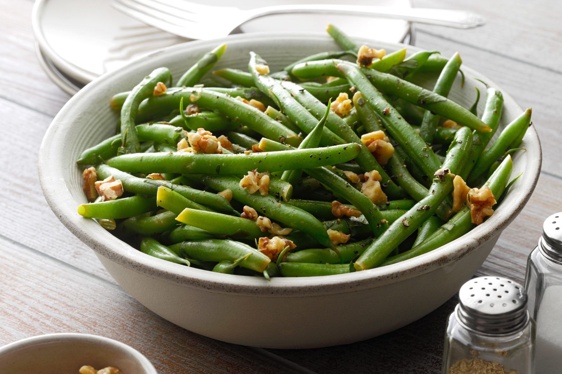 Instant Pot Green Beans served in a bowl with seasoning on side 