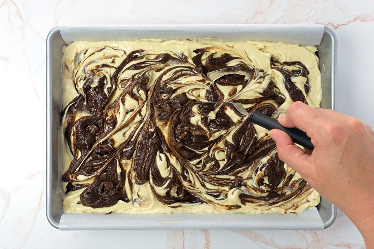 Swirling brownie batter and peanut butter cream cheese together to make peanut butter swirl brownies for Taste of Home RMS 11889