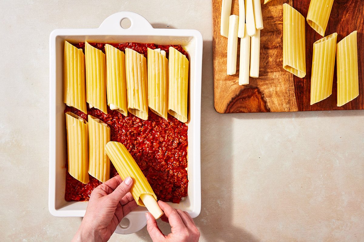 String Cheese Manicotti Step 4- filling manicotti shells with string cheese
