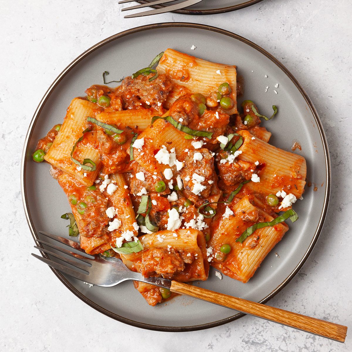 Single Servings Of Taste Of Home Pasta With Sausage and Peas Garnished With Feta And Basil