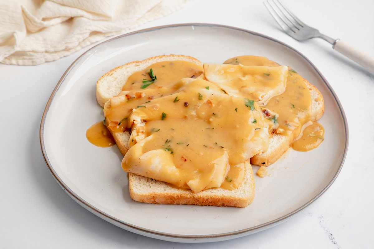 Beauty shot for Taste of Home Open Faced Turkey Sandwich, cooked and being served with gravy on a plate.