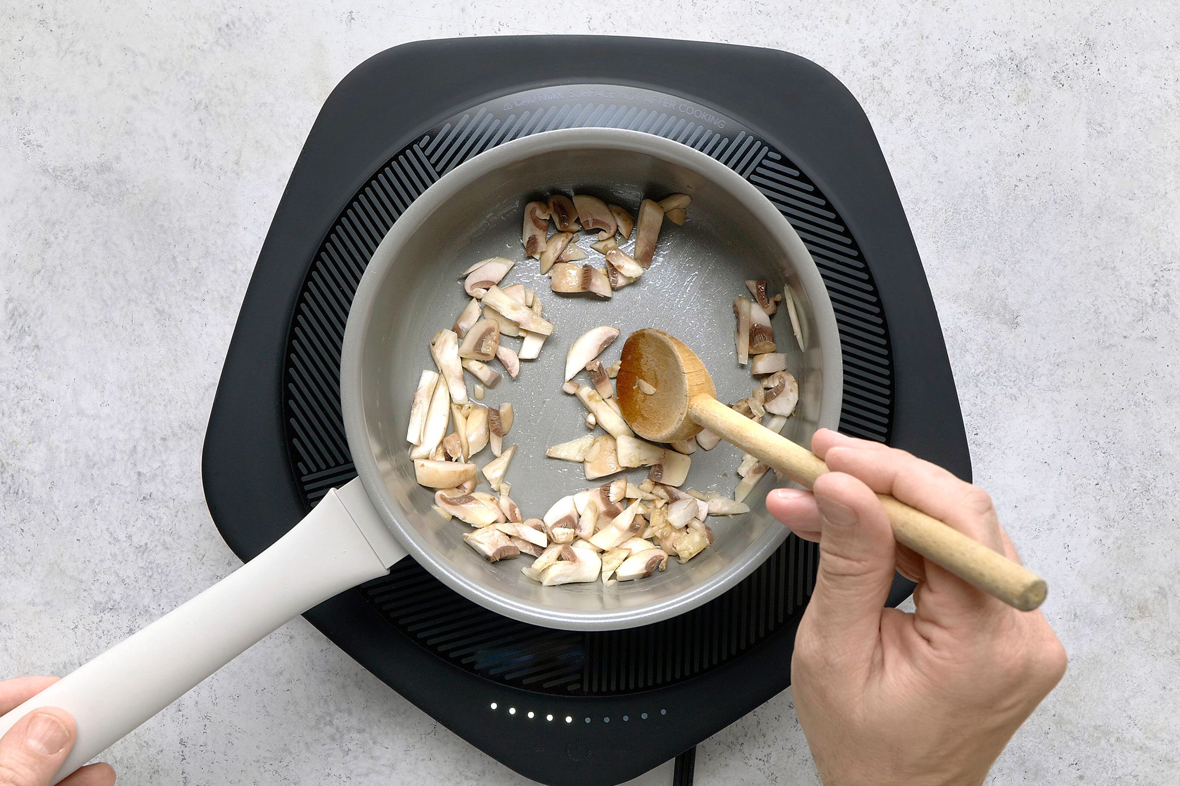 Mushrooms sauté in butter in a saucepan