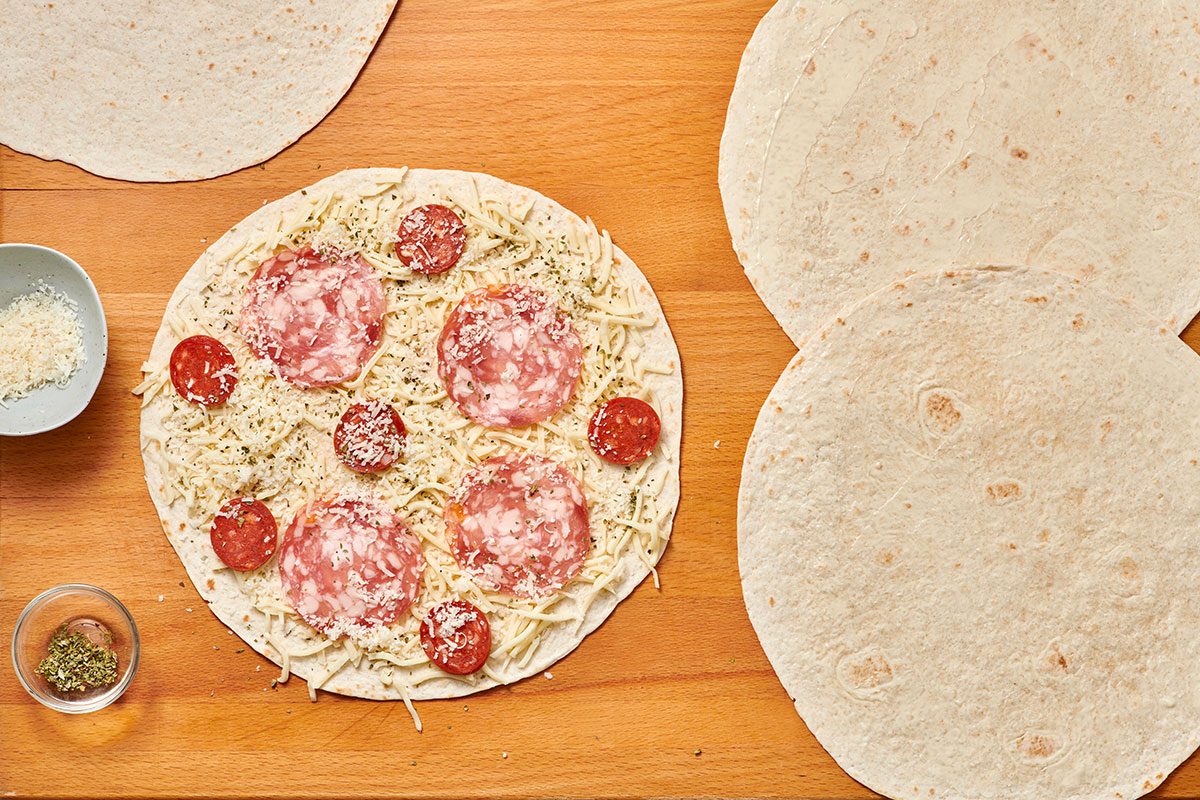 Assembling quesadillas on a cutting board