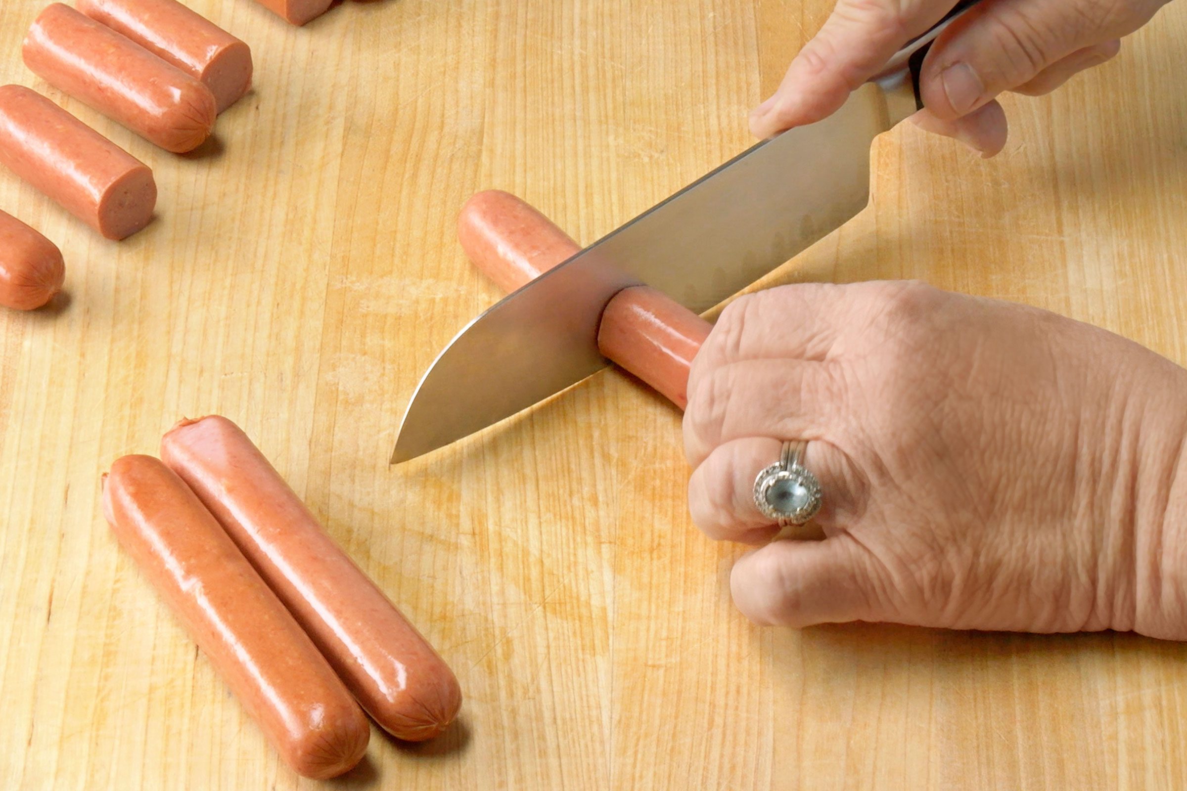 Cutting hot dog in half width wise
